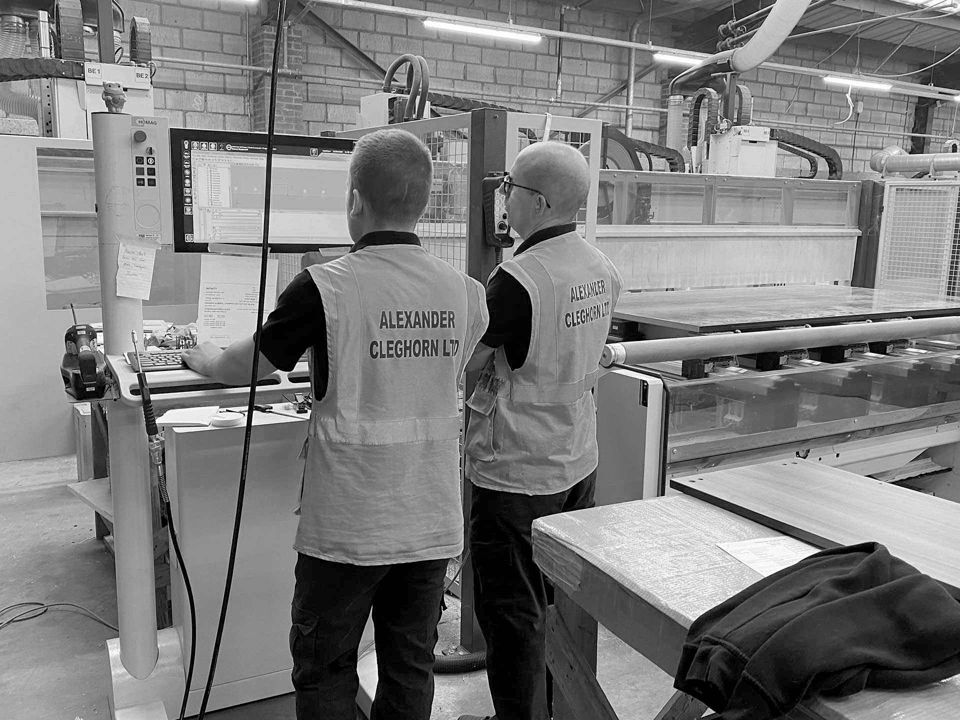 Employees overseeing Computer Aided manufacture process